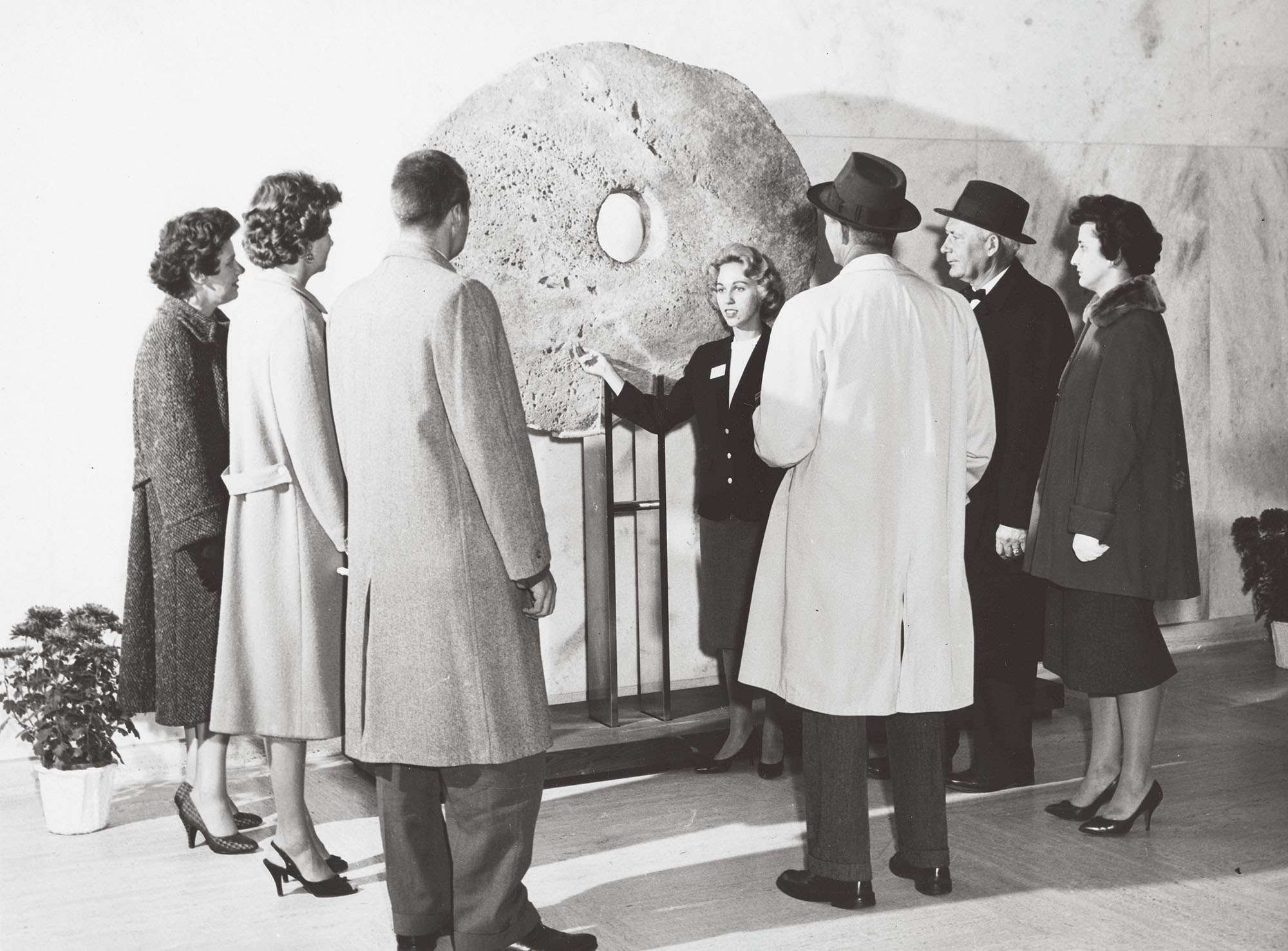 Bank of Detroit Museum of Money guide Lynn Wesson explains Yap money to museum visitors, 1960. Photographer unknown. Collection of Federated States of Micronesia Library of Congress.