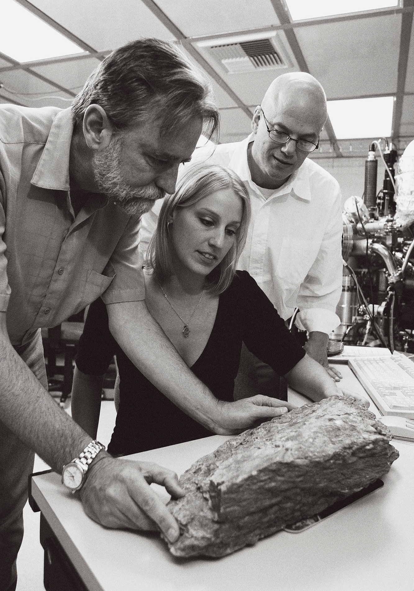 University of California Los Angeles’ Michelle Hopkins, graduate student in Earth and Space Sciences, Mark Harrison, Director of the Institute of Geophysics and Planetary Physics, and Craig Manning, Professor of Geology and Geochemistry examine zircon from the Jack Hills, Western Australia, prior to its analysis with a high-resolution ion microprobe. Photographer: Reed Hutchinson, UCLA.