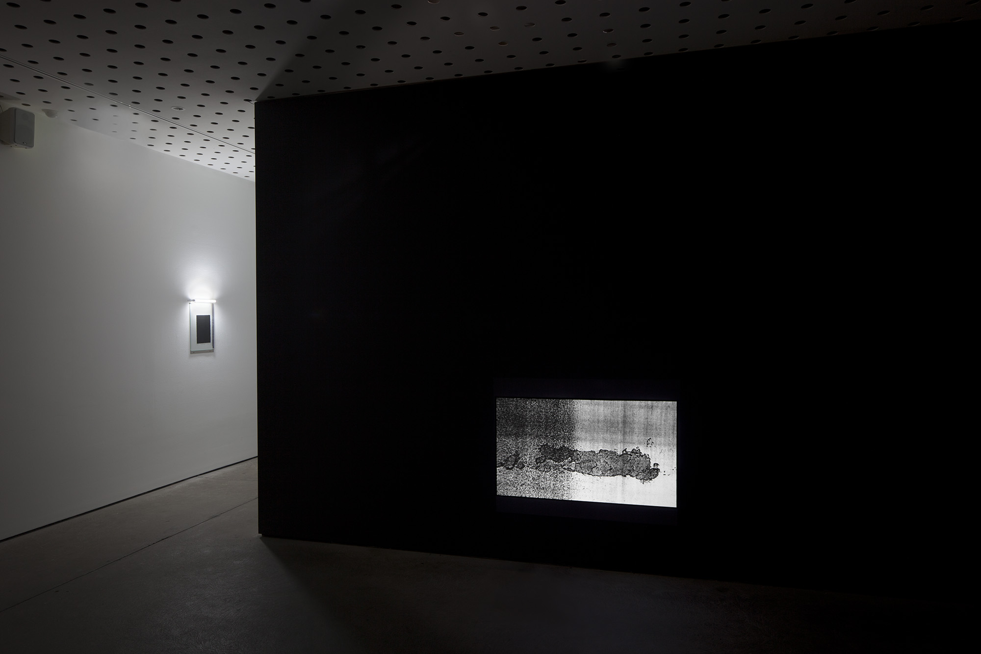 _Some Kinds of Duration_, 2011. Installation View, CCP - Centre for Contemporary Photography, Melbourne Australia, 2012. HD video colour, silent, concrete, fluorescent light, steel, carbon.